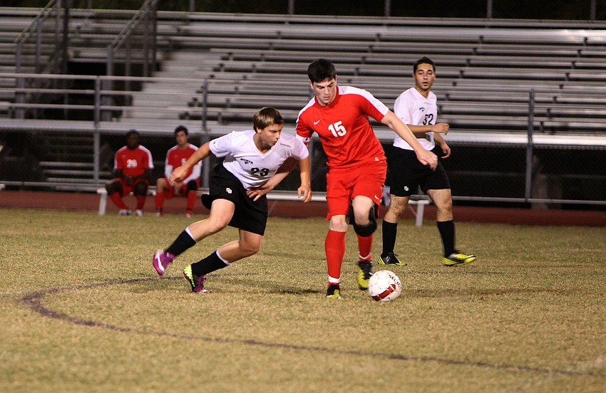 Bookerâ€™s Eric Guendl, No. 23, and Cardinal Mooneyâ€™s Andrew Abrams, No. 15, fight over the ball.