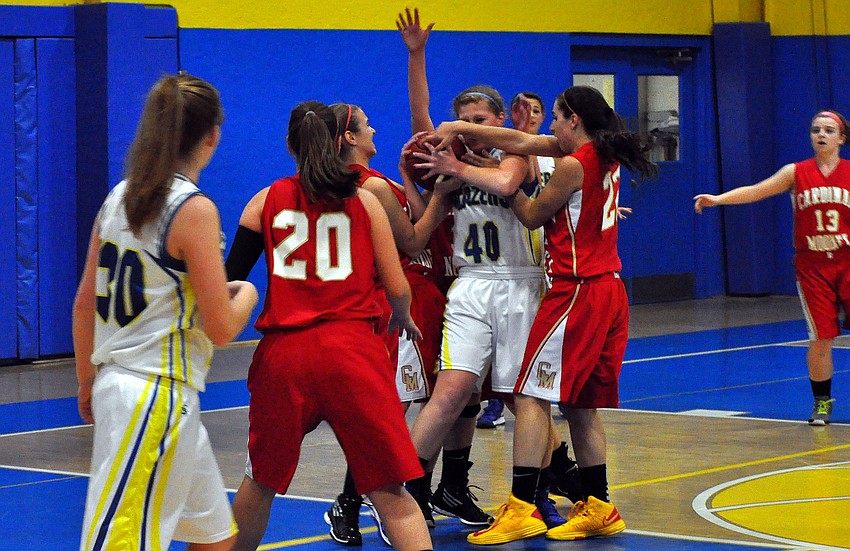 Sarasota Christianâ€™s Jordan Moon, No. 40, tries to hold onto the ball while Cardinal Mooneyâ€™s defense tries to get it back.