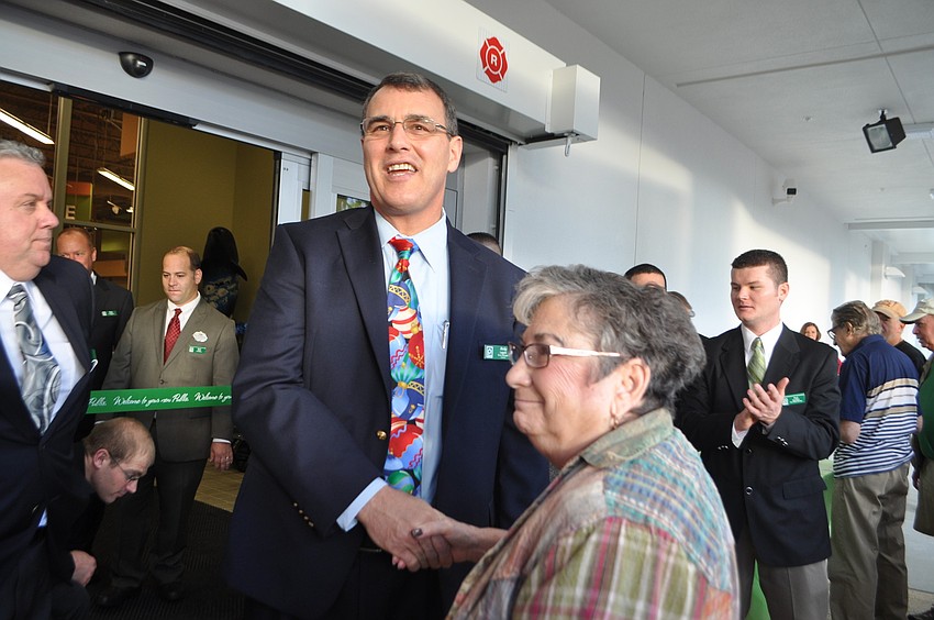 Store manager Andy Lappin greets Joan Sinder, who was the first customer to walk through Publix doors.