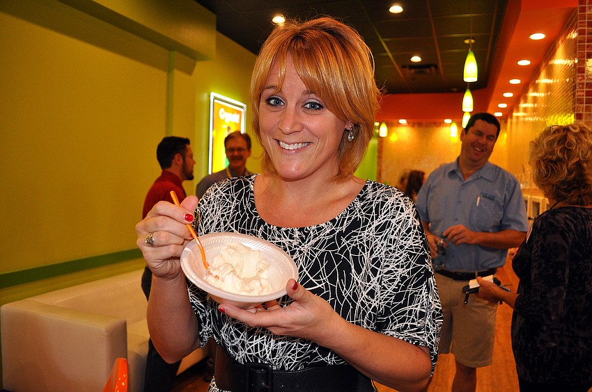 Jamie Overmiller enjoys some frozen yogurt Thursday, Dec. 13, at the Sarasota Chamber of Commerceâ€™s Breakfast with a BANG at Orange Leaf Yogurt.