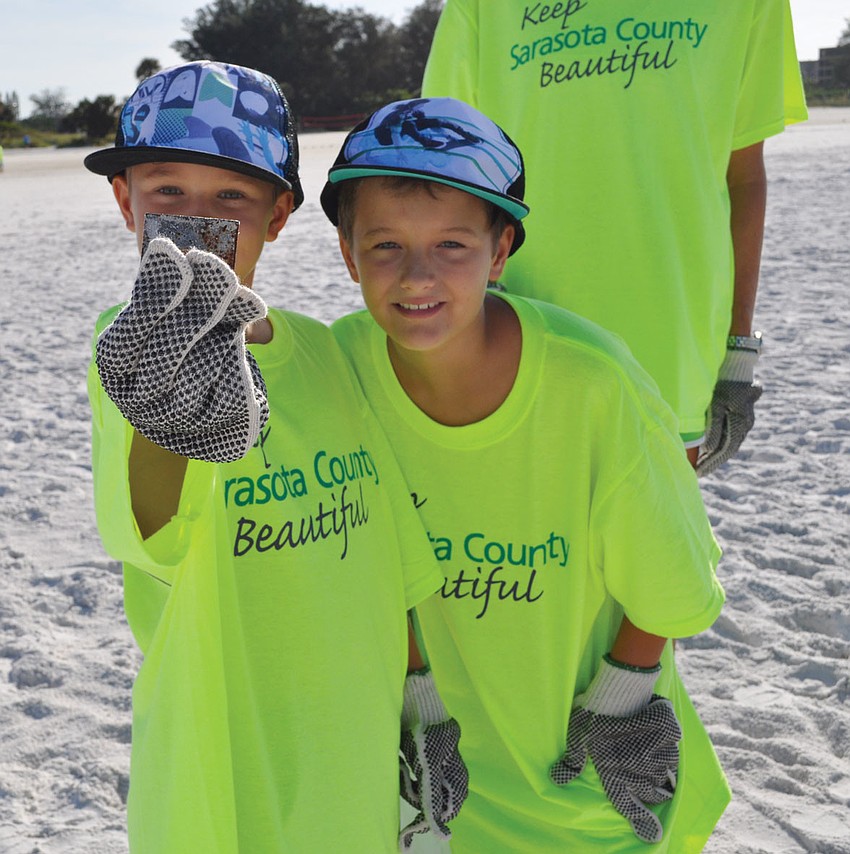 Dylan Colby, 8, and his brother Clay, 10, found a chunk of metal Sept. 15,during the 2012 International Coastal Cleanup on Siesta Key beach.
