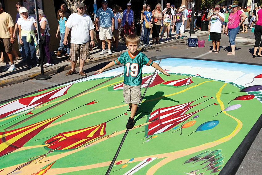 Lincoln Sibley, 6, walks across the tight rope on one of the 3-D chalk pieces at the Sarasota Chalk Festival, which was held Oct. 28 through Nov. 6.