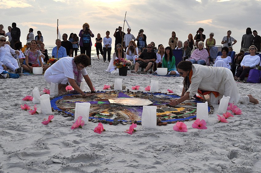 Patricia Cockerill and Zan Benham swept all the sands into a spiral, blending and putting some of it on the center of the mandala.