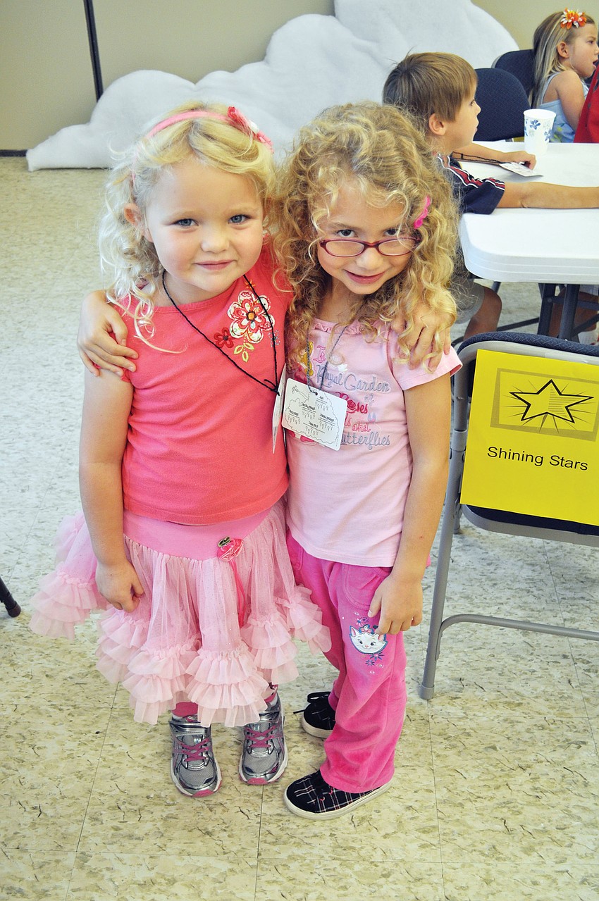 Zoey and Emma take a break from snack time during the first day of First United Methodist Churchâ€™s Vacation Bible School.