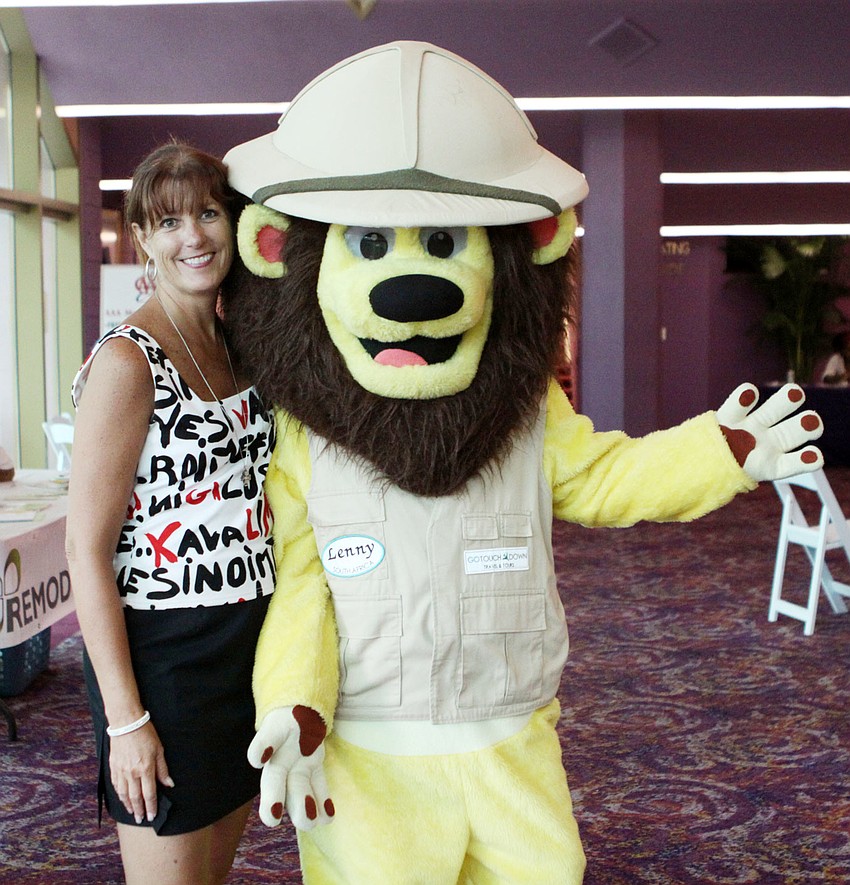 Tammy Halsted and Lenny the Lion pose together inside the Van Wezel during Friday Fest.
