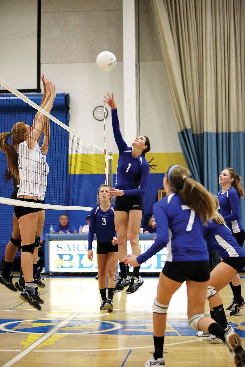 Nicole Wittmer, right, hits the ball over the net during Sarasota Christian Schoolâ€™s game against Lake Worth Christian.