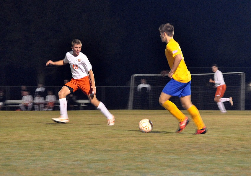 Sarasota High Schoolâ€™s Stone Barcomb, No. 13, tries to stay ahead of Sarasota Military Academyâ€™s Logan Moriarty, No. 10.