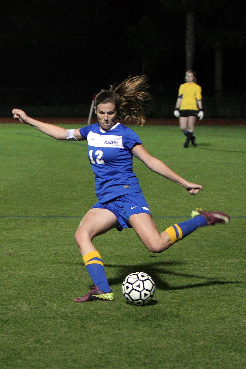 Sarasota Christianâ€™s Kelsey Murphy, No. 12, prepares to kick the ball up the field to her teammates.