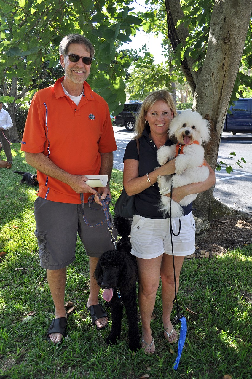 Andy and Melissa Owens show off their Gator pride with their dogs Tebow and Bon Jovi.