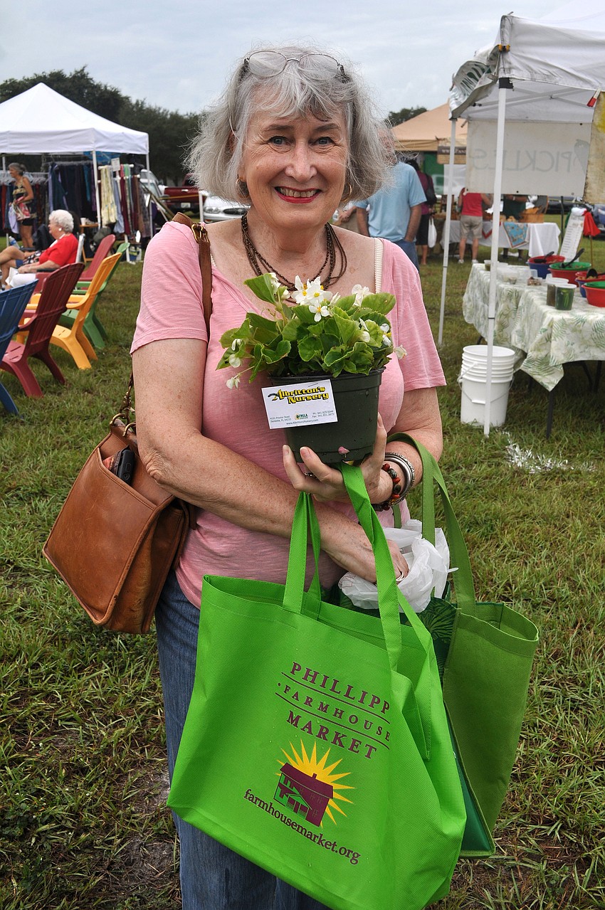 Mary Wildrick was one of the raffle winners Wednesday, Oct. 3 during the opening day of the Phillippi Farmhouse Market. She won a Phillippi Farmhouse Market tote bag filled with goodies and a begonia.