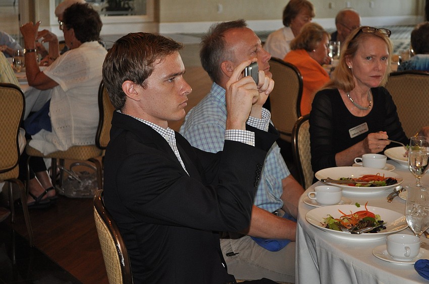Jacob Morton takes a photo of Keith Fitzgerald, Congressional candidate for newly formed 16th District, Tuesday, October 9, at the Longboat Key Democratic Club luncheon.