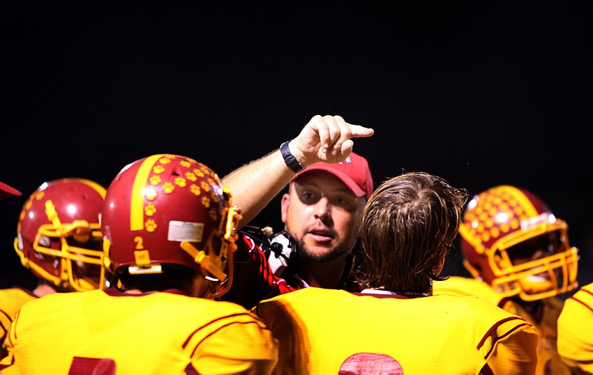 Head coach Joshua Smithers talks to his players during a timeout Friday, Oct. 12.