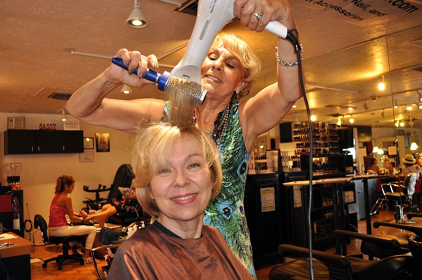 Bobbie Tuccinardi blows out Gail Emmottâ€™s hair Sunday, Oct. 14, during the Martinis and Makeovers event.