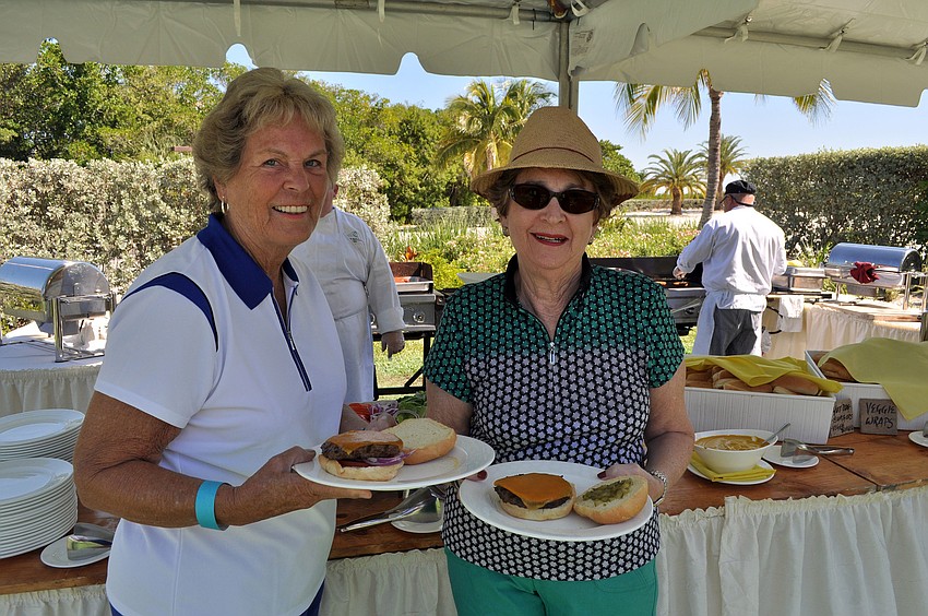 Nancy Mueller and Sharon Schreiber get some food Sunday, Oct. 21, during the Hal and Hazel Lenobel Appreciation Day picnic at the Longboat Key Club Harbourside.
