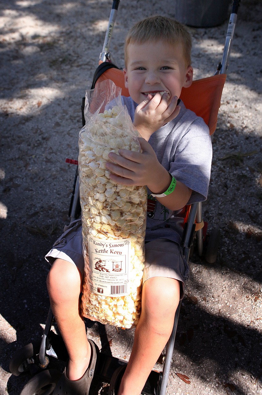 Henry Salter, 4, enjoys eating a large bag of kettle corn.