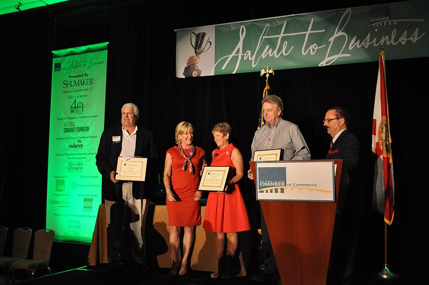 Jerry Moore of Pope Golf, Susanne Wise of Take Care of Sarasota Private Duty Home Health Care and Scott Christensen of Costco accept their awards for the Hiring our Neighbors category.