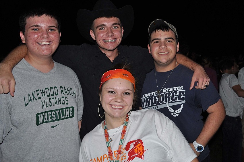 William Marsh, Kenny Inman, Vincent Butz and Shayla Boe, front, watched the bonfire get started Oct. 25.