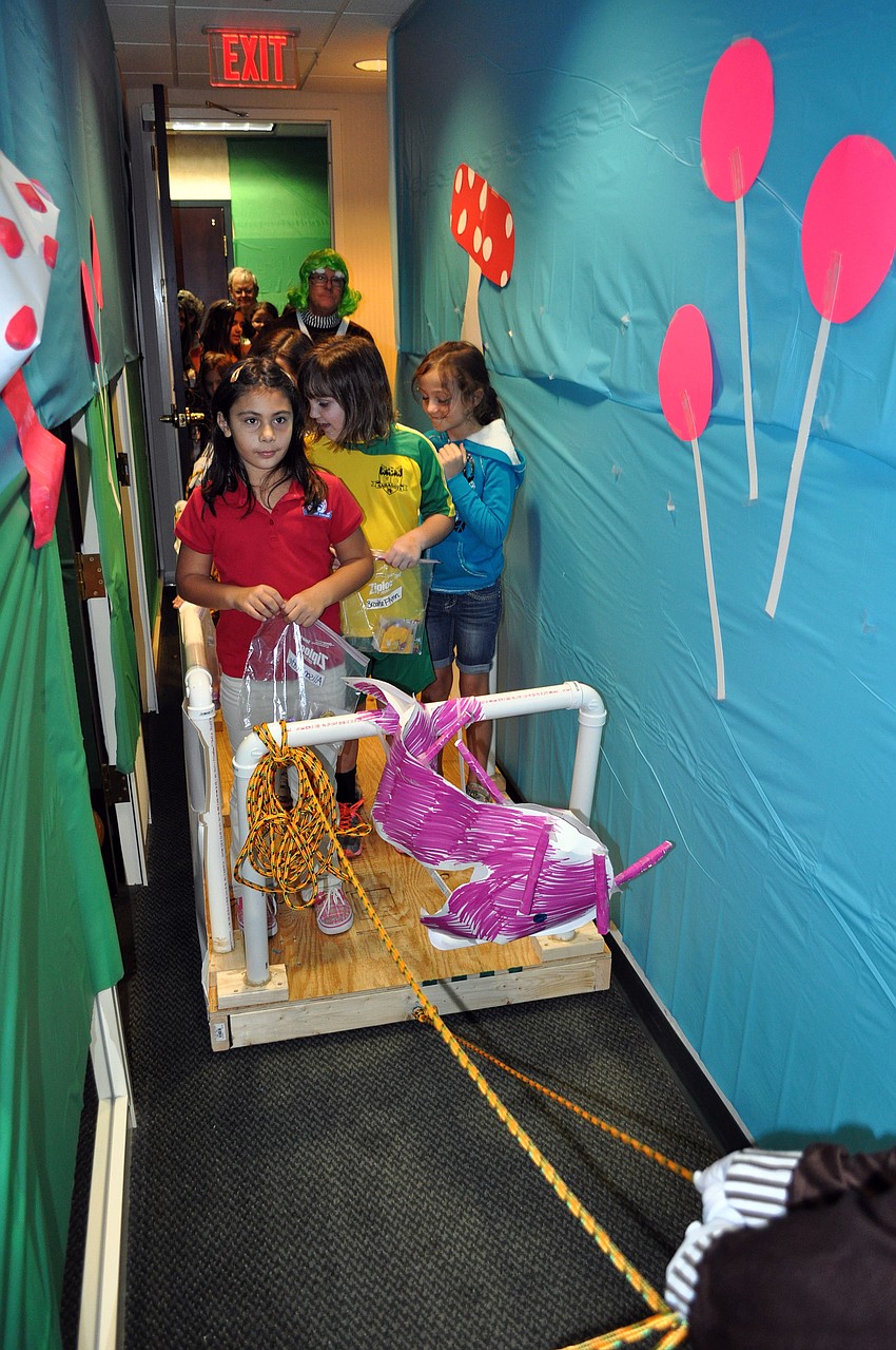 Girls Inc. girls have fun on the Willy Wonka ride made by the people who work at UBS Wednesday, Oct. 31, inside their office.