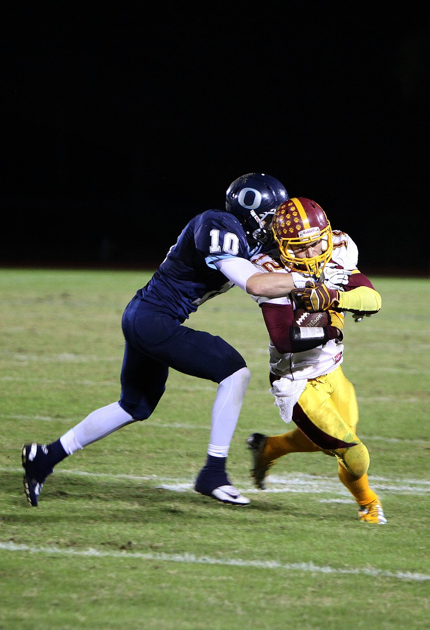 Tyler Dietrich, No. 10, attempts to tackle Anthony Caiazzo, No. 12.