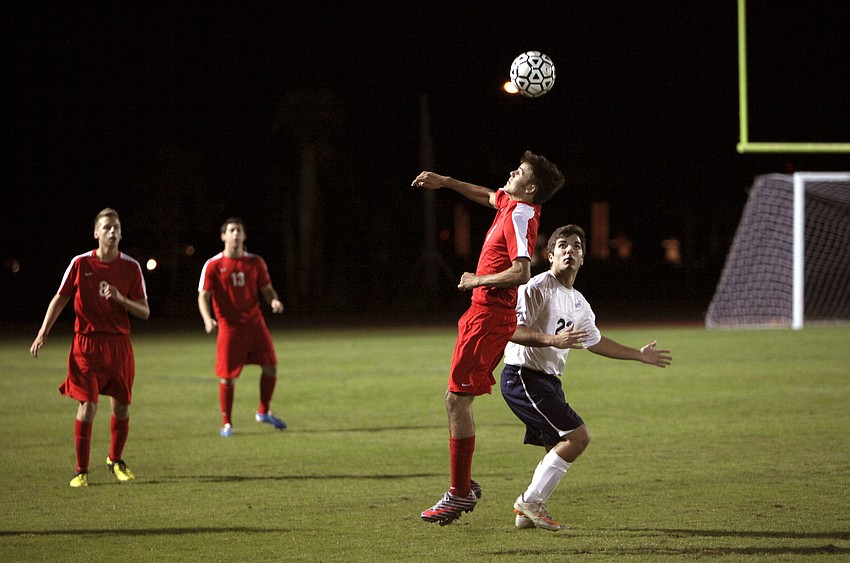 Cardinal Mooneyâ€™s John Rodman, No. 3, heads the ball.
