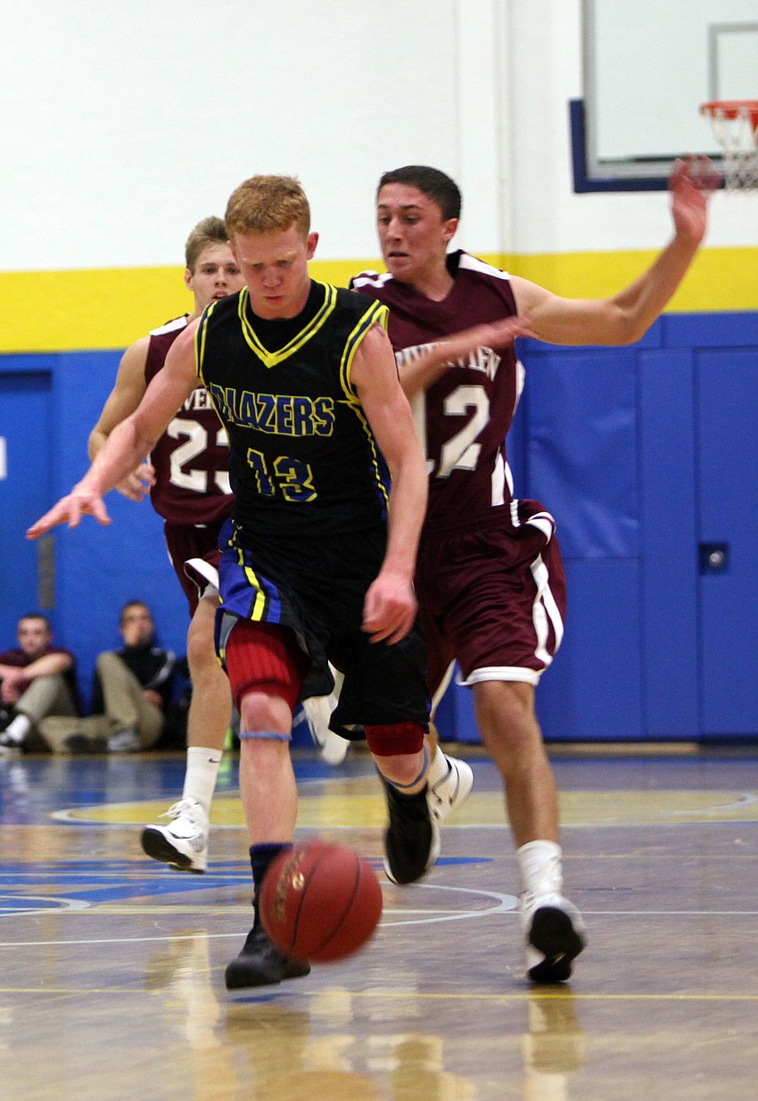 Blake Morrow, No. 13, dribbles the ball down the court.