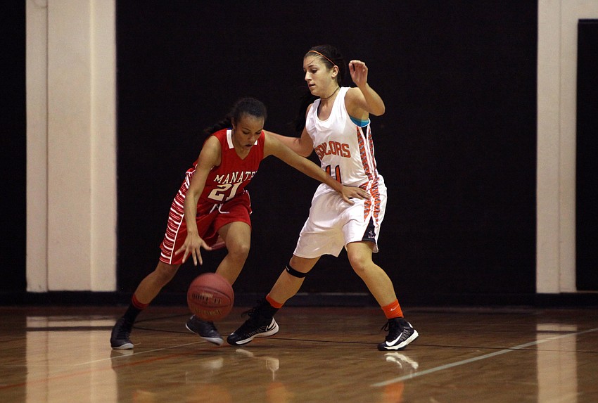 Jada Guion, No. 21, tries to keep the ball away from Kylie Warner, No. 11, during Tuesday night's game at Sarasota High School.