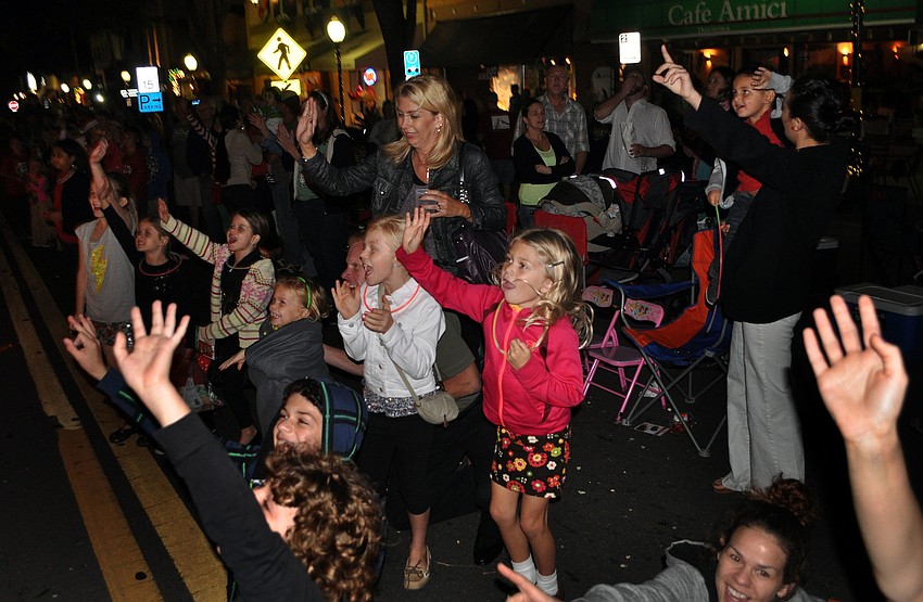 Kids scream and wave as Santa rides by Saturday, Dec. 1, during the Downtown Sarasota Holiday Parade.