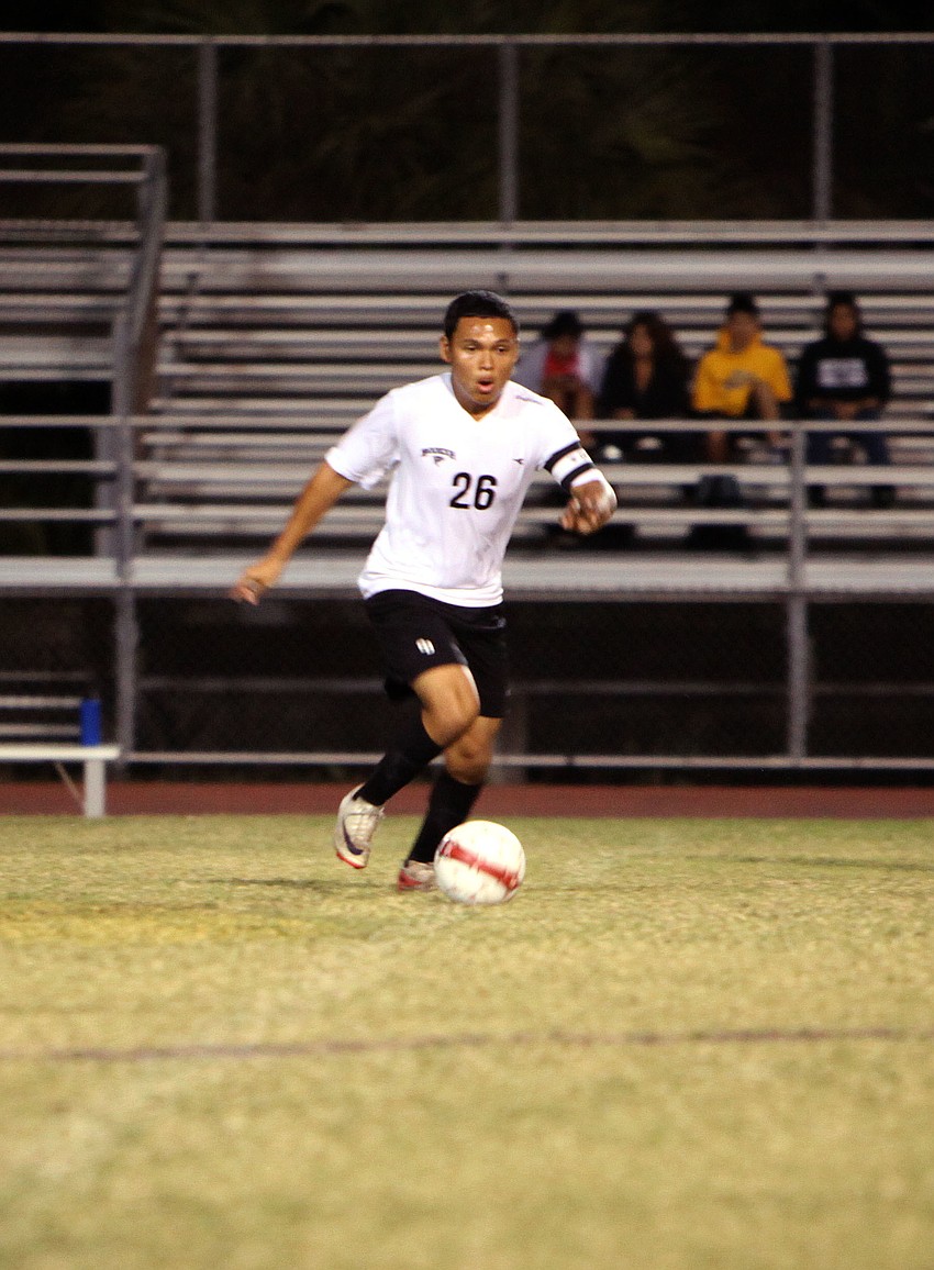Bookerâ€™s Alejandro Esqueda, No. 36, runs across the field with the ball.