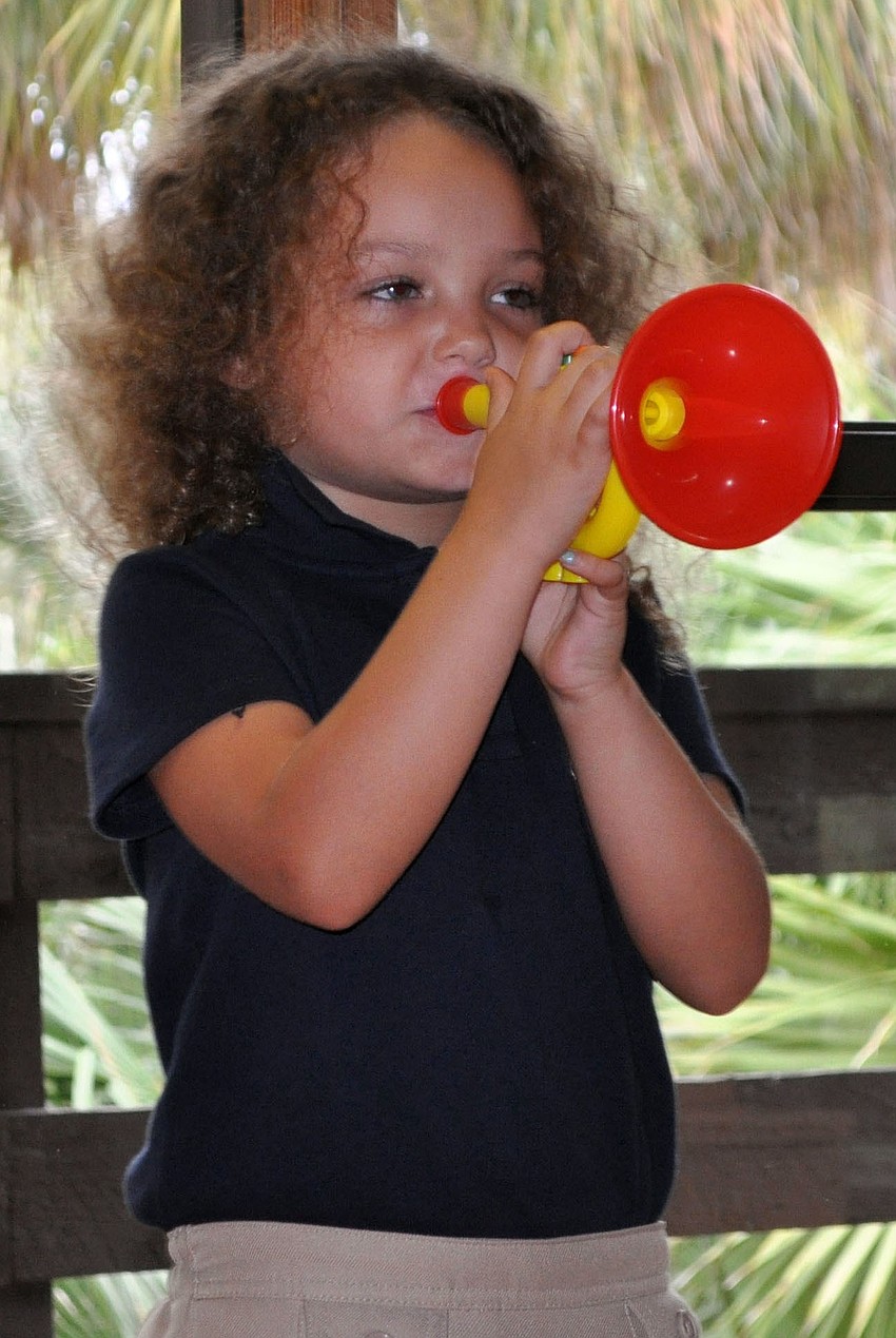 Kirin Malisoff blows a toy horn to start off â€œMarch of the Toysâ€.