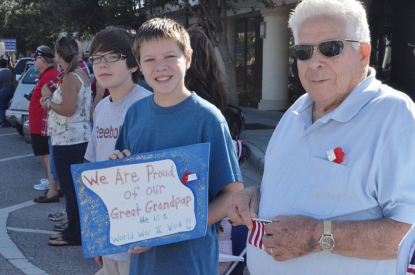 J.P. and Zachary Manning made a sign to recognize their great-grandfather and World War II veteran, John Mul, Nov. 11, at the Sarasota Veterans Day Parade.