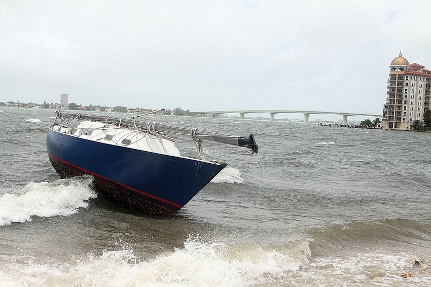 A sailboat rocks back and forth close to the shore at Island Park after Tropical Storm Debby.