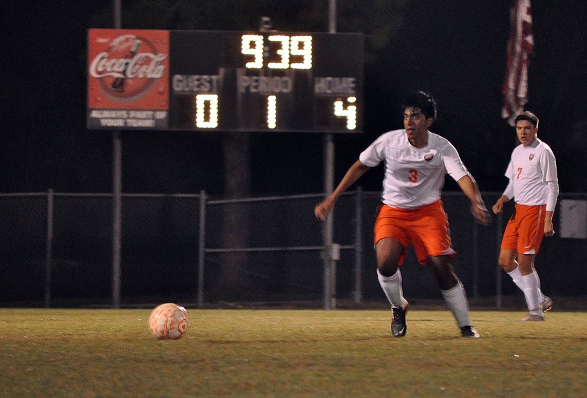 Victor Martinez, No. 3, dribbles the ball down the field.