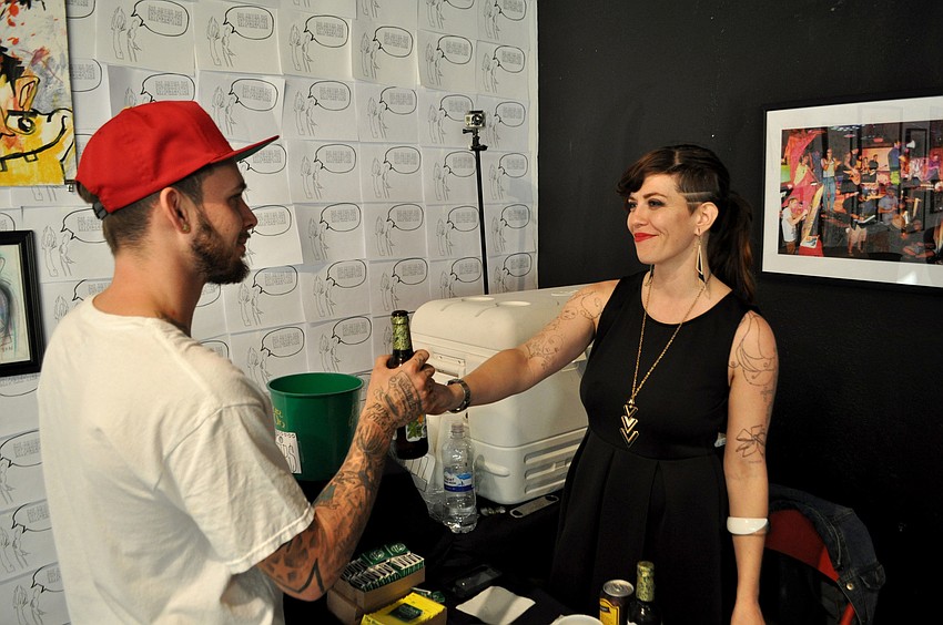 Roger Naughton gets a beer from the Shamrockâ€™s Tucker Lenora