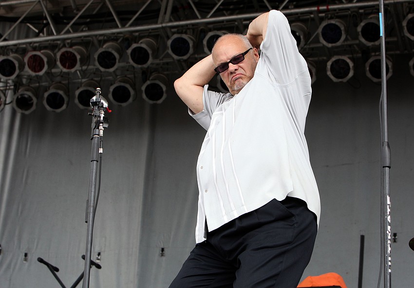 Curtis Salgado walks onto the stage to the music of his band and does a little pelvic thrust.