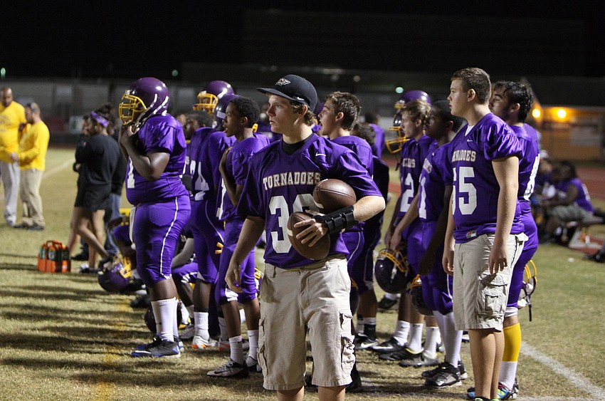 The Tornadoes watch their fellow teammates from the sidelines.