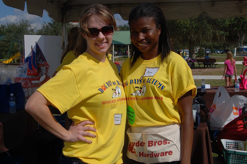 Worker for the Humane Society, Stephanie Romanelloand volunteer for the Humane Society, Anne Telcy smile for a picture while supporting Dog Days of Autumn.