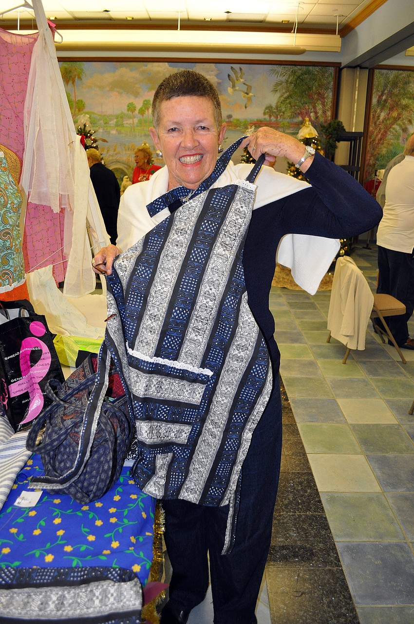 Ann Roberts shows off the apron she bought at the bazaar.