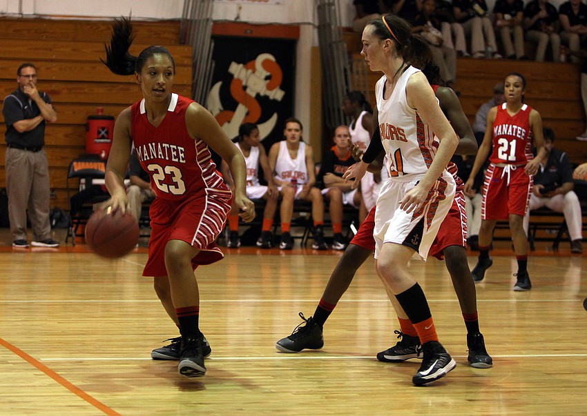 Manateeâ€™s Jasmine Luther, No. 23, keeps control of the ball while Sarasotaâ€™s Emily Harding, No. 11, stays close.