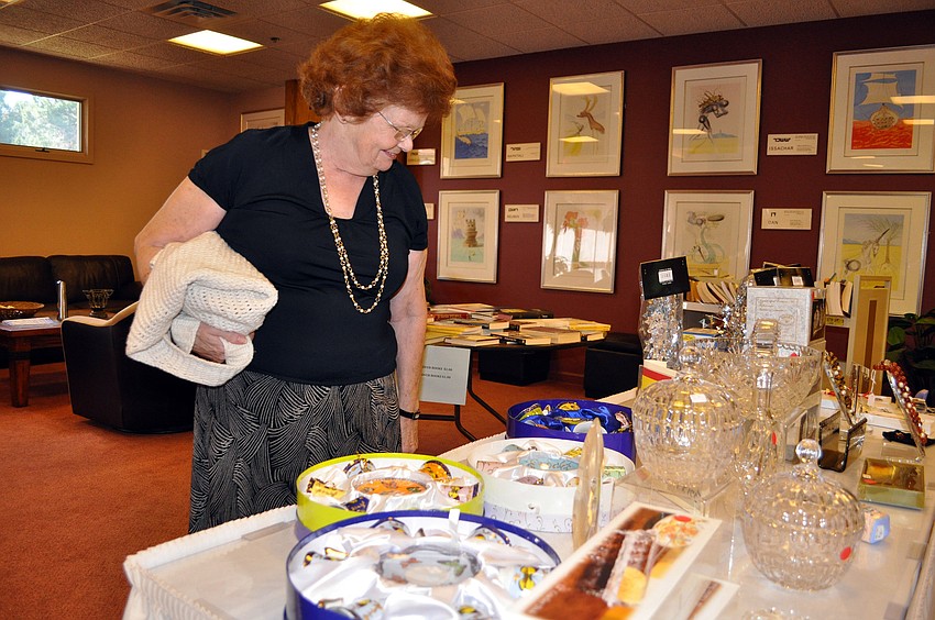 Arlene Scarlett peruses the merchandise for sale at Temple Beth Israelâ€™s Holiday Happening.