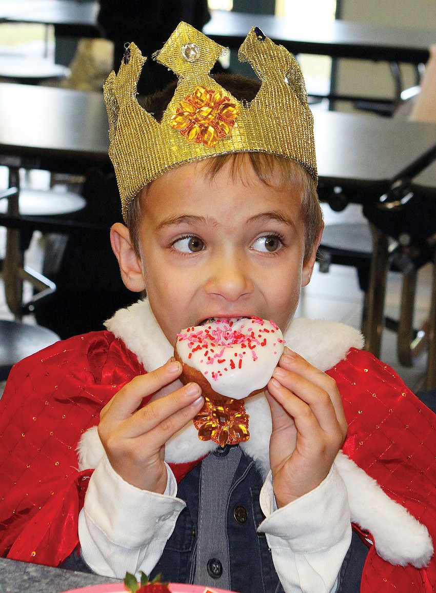 Alex Maxucci, 5, bit into his donut during Ashton Elementaryâ€™s Fairytale Parade and Breakfast.