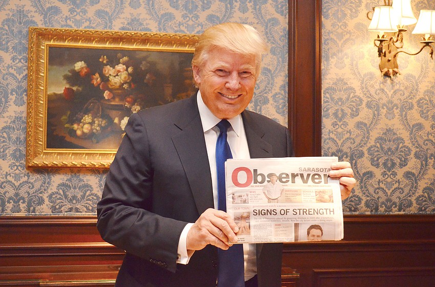 Donald Trump holding his copy of the Sarasota Observer.