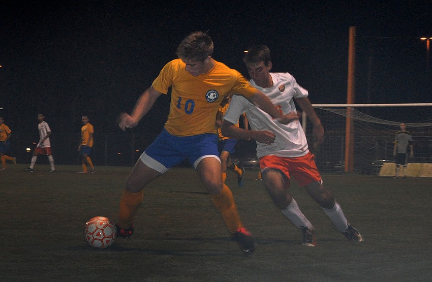 Sarasota Military Academyâ€™s Logan Moriarty, No. 10, tries to keep the ball away from Sarasota High Schoolâ€™s Conner Muldoon, No. 16.