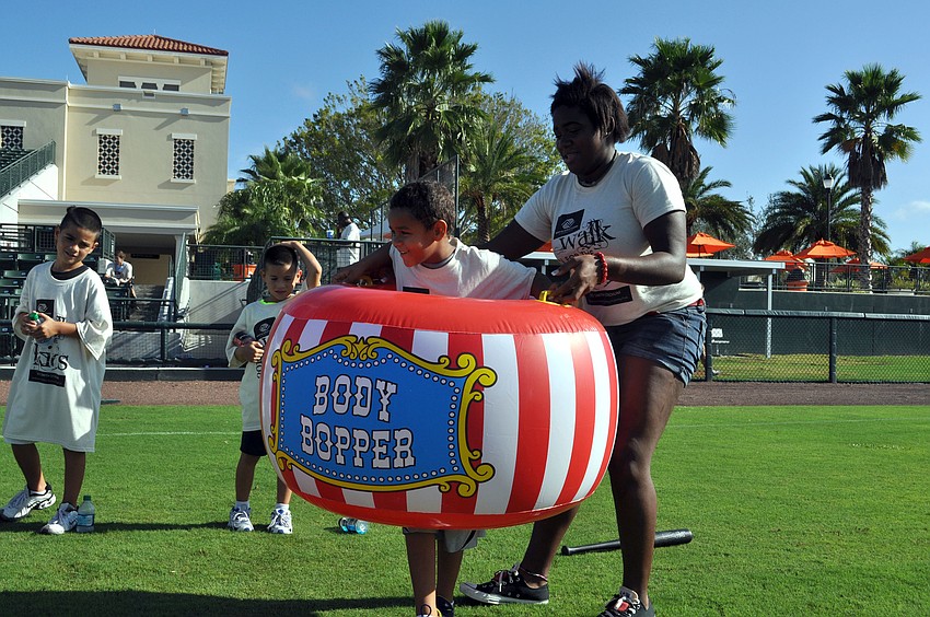 Maxine Ramsdell helps Ethan Alexander into an inflatable suit.