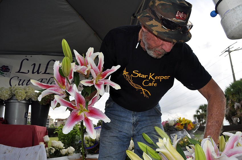 John Snyder works on finding the three best stems of his Stargazer Lilies at LuLuâ€™s Wholesale Cut Flower stand.