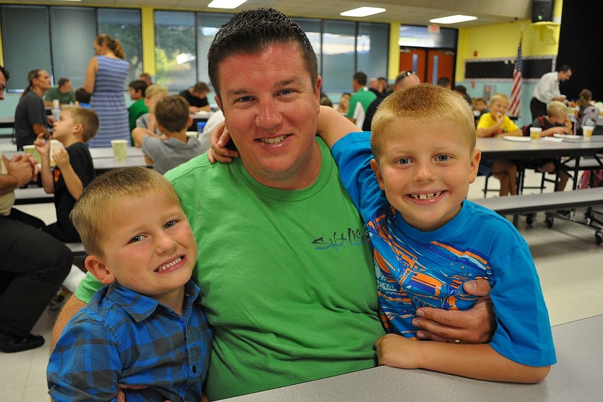 Liam and Aidan Hurley were eager to give their dad Bo, center, a hug.