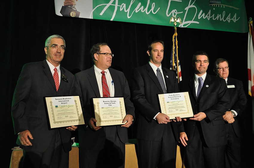 Rick Piccolo of the Sarasota Bradenton international Airpot, David Bowman, Sr. of Bowman, George, Scheb and Toale and Jeff and Jason Toale of Toale Brothers Funeral Homes accept their awards for the Anniversary Milestones category.
