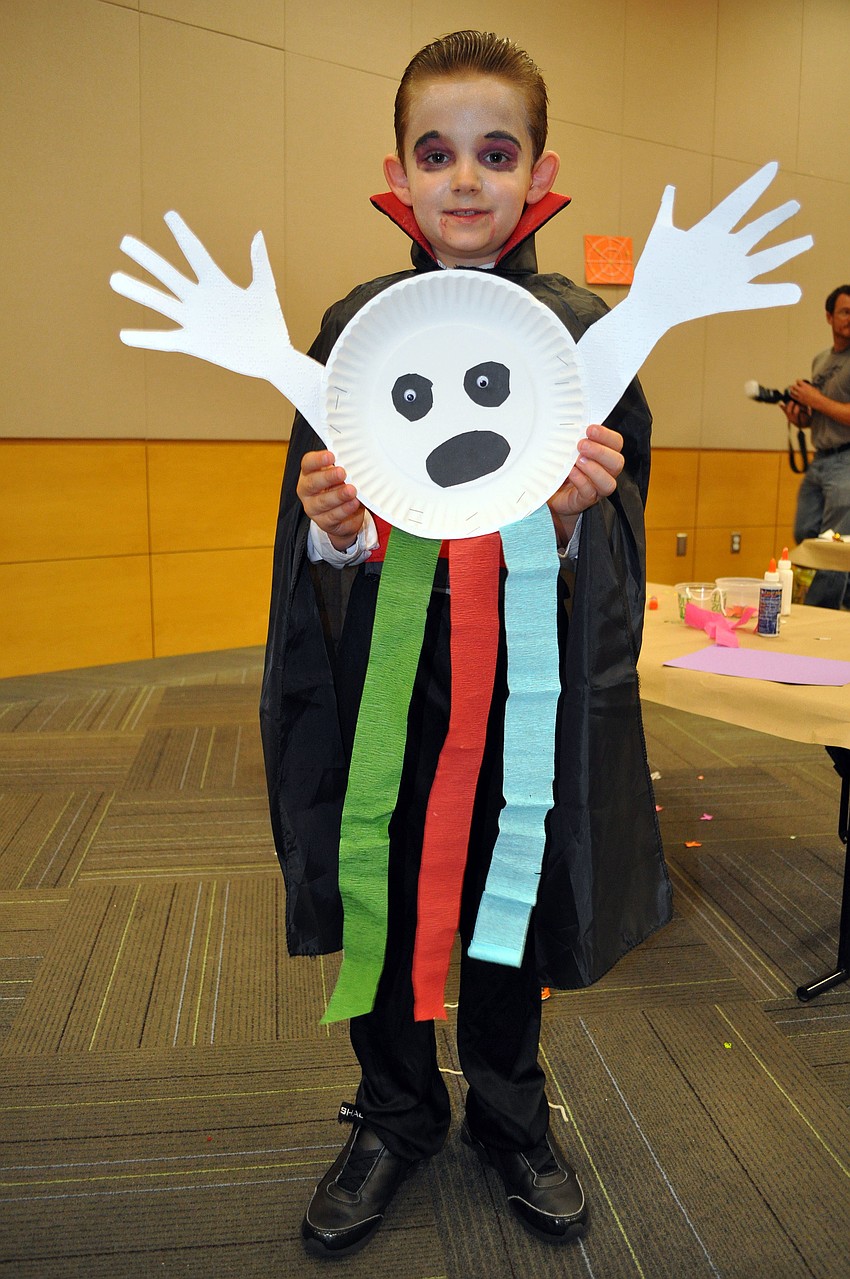 Ronnie Sartori, 7, shows off the ghost he made Wednesday, Oct. 24, at Selby Public Libraryâ€™s Halloween Party.