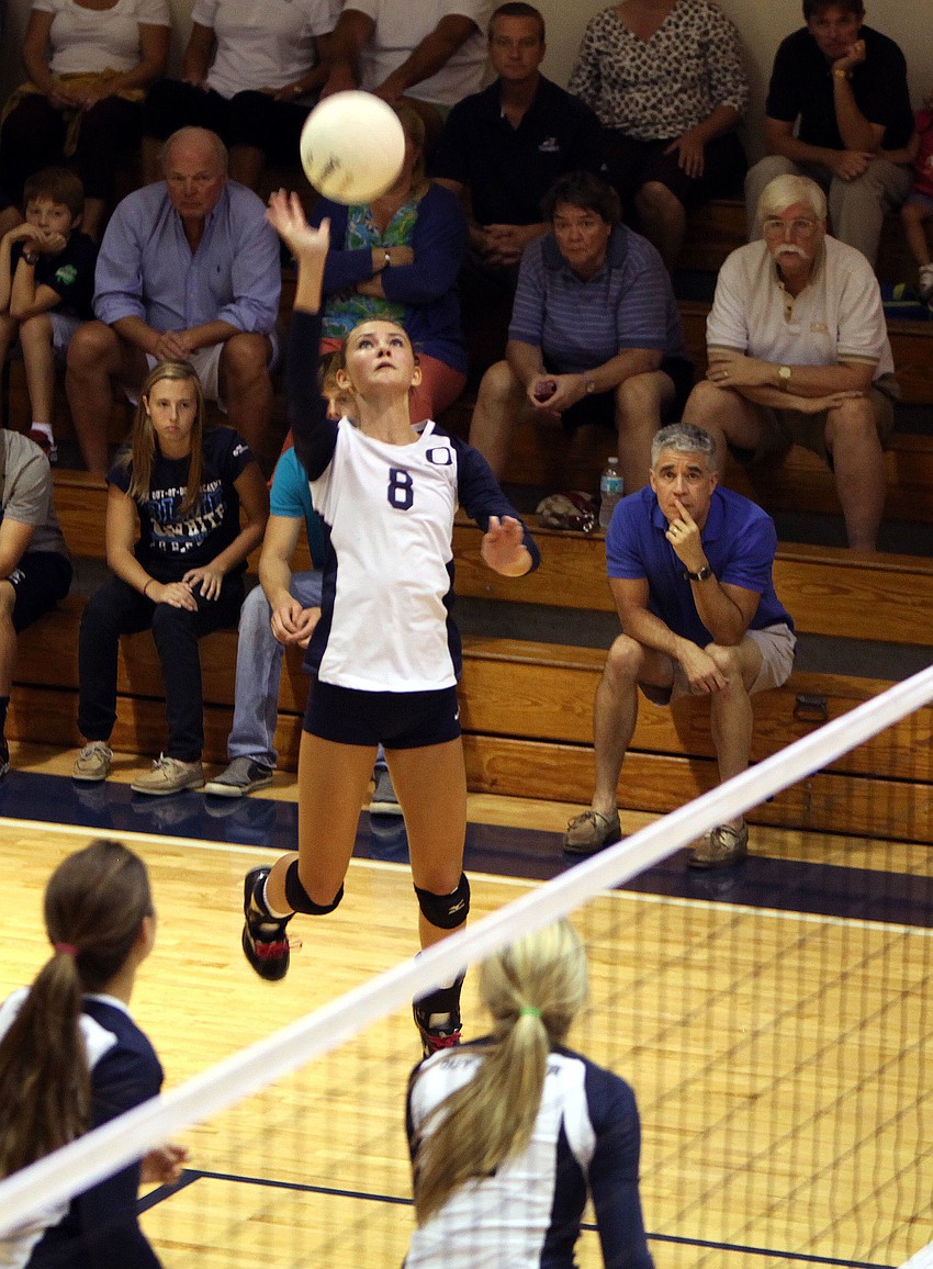 Lauren Maxey, No. 8, gets up high as she goes to spike the ball.