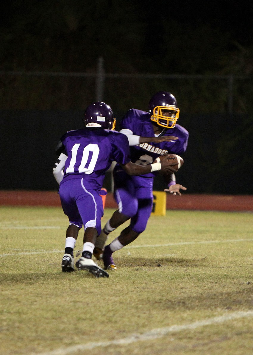 Brandon Brown, No. 10, hands off the ball to Marlon Mack, No. 2.