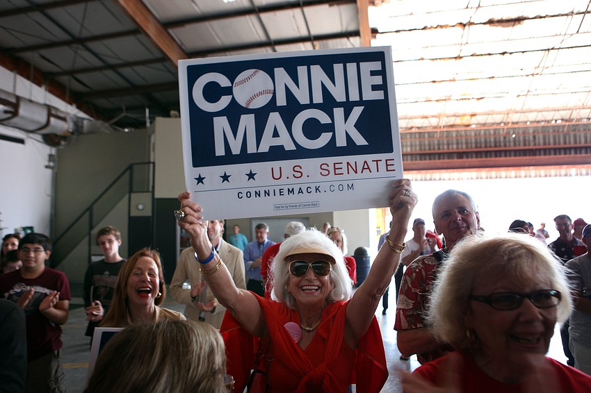 Graci McGillicudy holds up a sign in support of her nephew, Connie Mack.